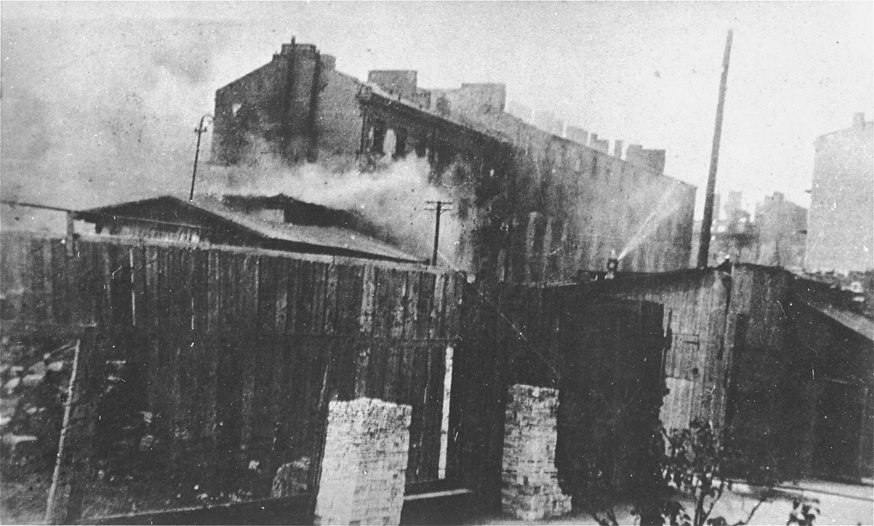 Apartment buildings burn during the suppression of the Warsaw ghetto uprising.