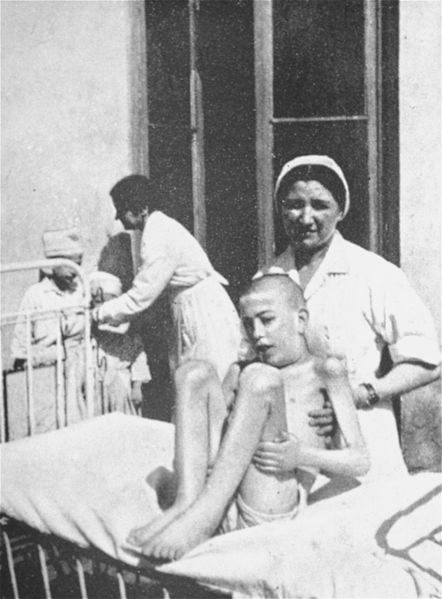 Nurses attend to starving children in a hospital in the Warsaw ghetto.