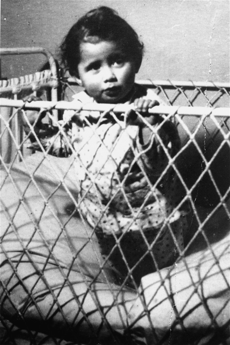 Ewa Kupferblum looks out from her crib in the Warsaw ghetto.