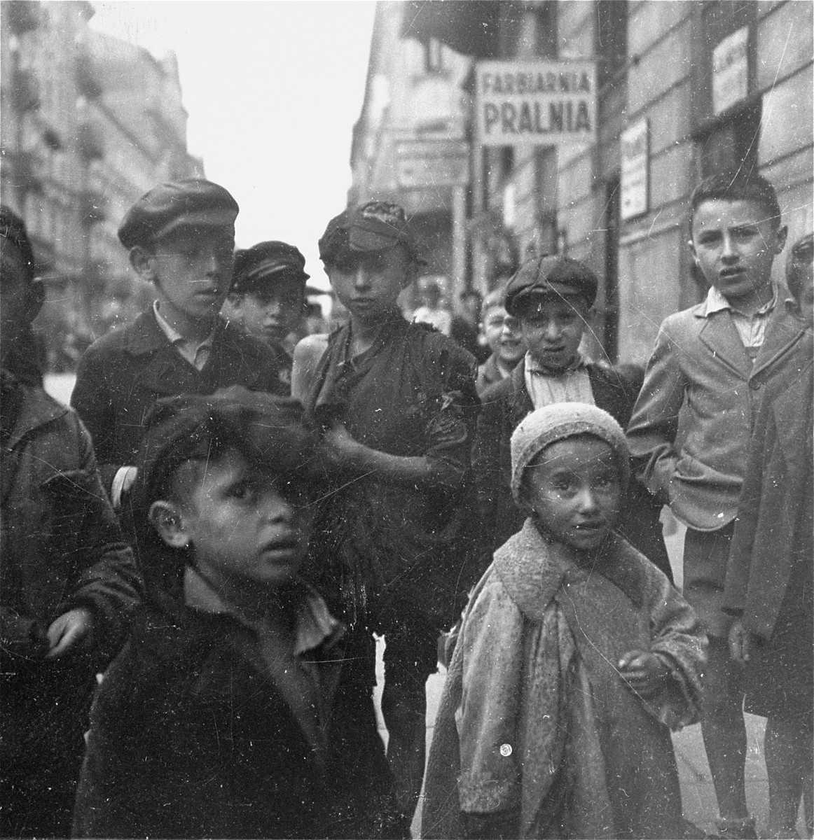 Children on the street in the Warsaw ghetto.  

Joest's original caption reads: "The hunger and misery of most of the children one saw showed more in their clothing than in their faces."