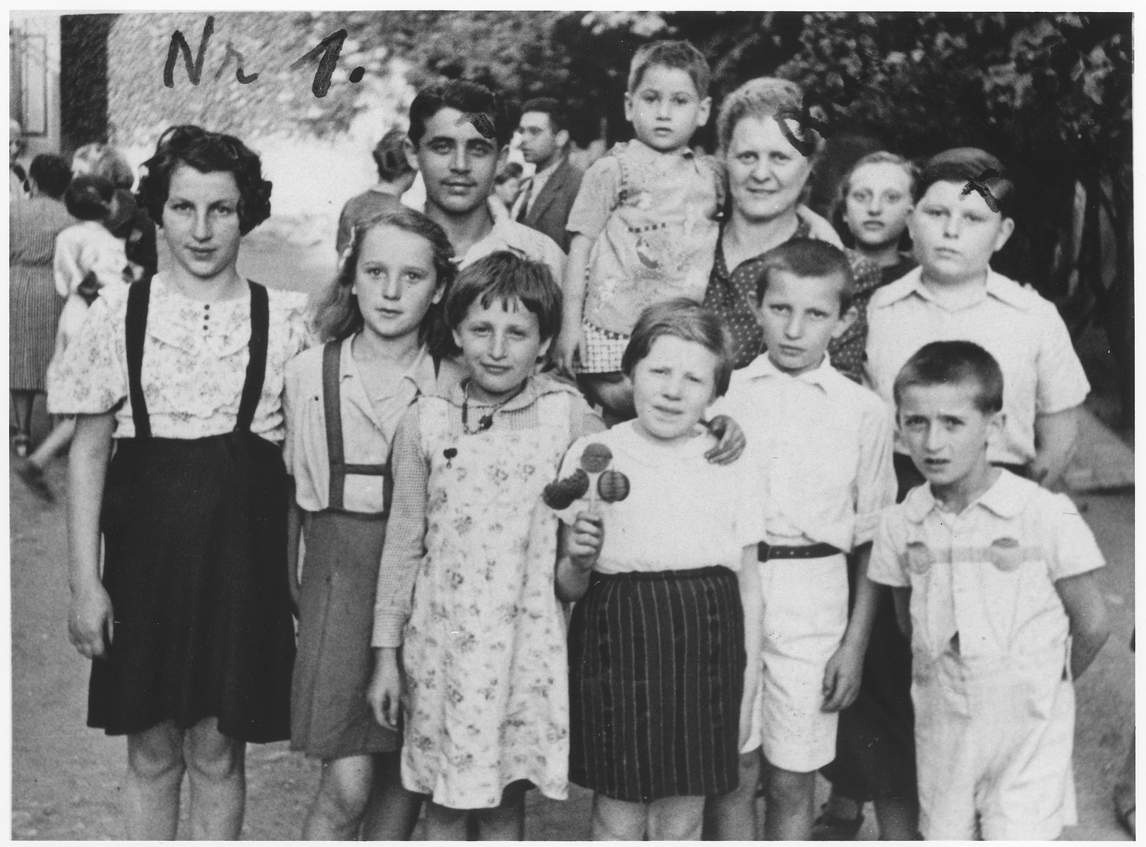 Anny (Hubner) Andermann poses with a group of orphans whom whe helped to have repatriated from Transnistria.

The boy on the right, Poldy, was a frequent visitor in the Andermann home.