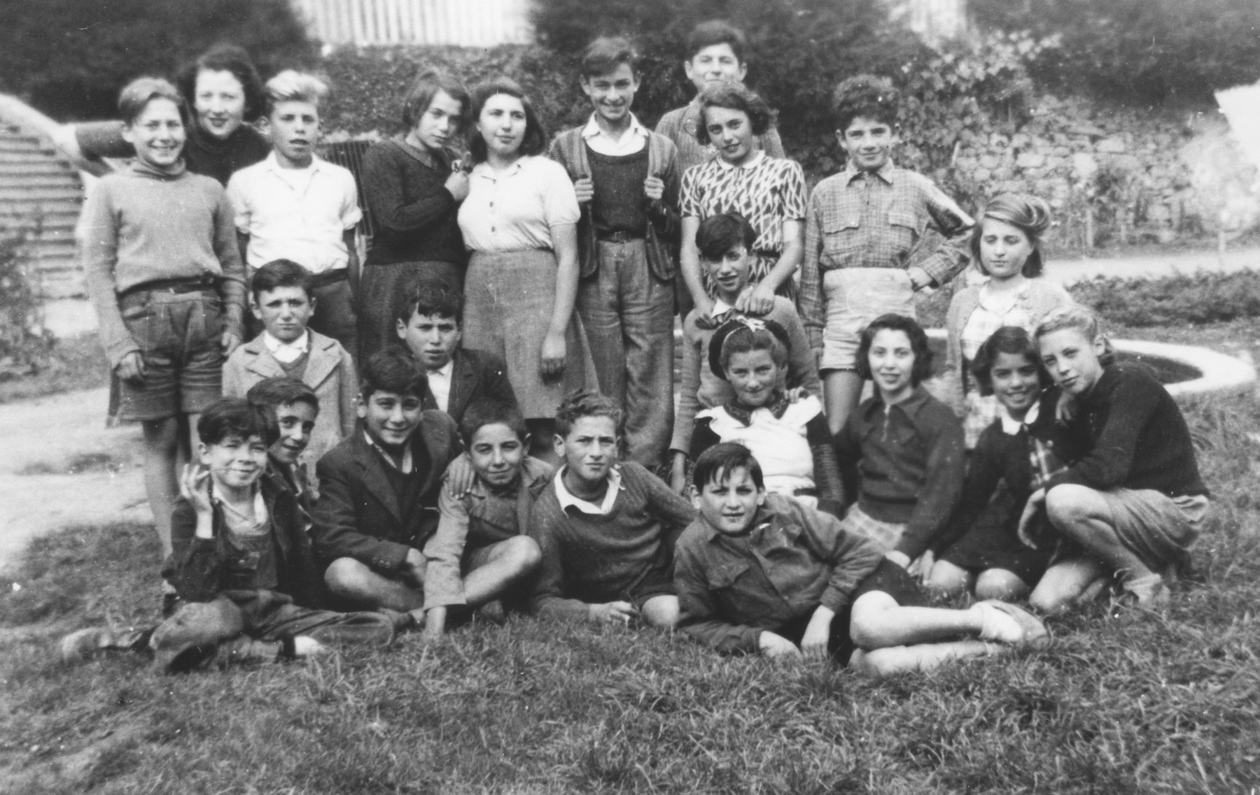 Group portrait of Jewish children at the OSE (Oeuvre de Secours aux Enfants) children's home at the Château Masgelier.  

Edith Loeb is pictured standing second from the right with her arms on the shoulders of Kurt Leuchter.  The two were married in New York in 1950.  Also pictured are Francine Knopf (kneeling front row, far right), Jorette (to Francine's left), and Renee Spindel (kneeling second row, far right).  Standing left to right are Herbert Friedman, Marianne, Jacques Schlief, [unidentified], and Rebecca Sendyk (fifth from the left). Hermann Rosenfeld is  pictured second row, second from the left.