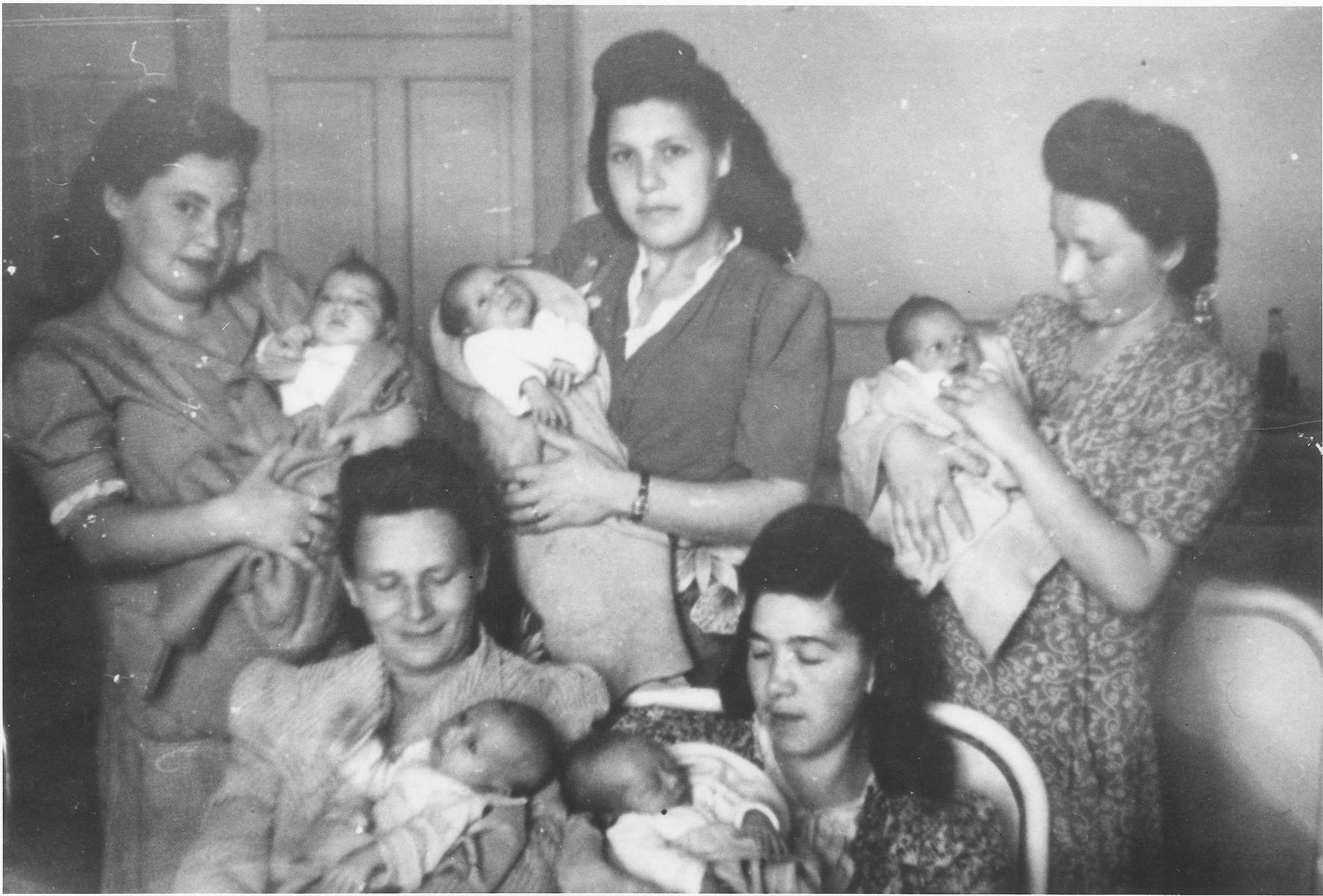 Five new mothers pose with their infants in the maternity ward of the Elizabeth Hospital in the Feldafing displaced persons camp.

Among those pictured is Zlata (Distel) Malcmacher holding Rascha Riwka (top left).