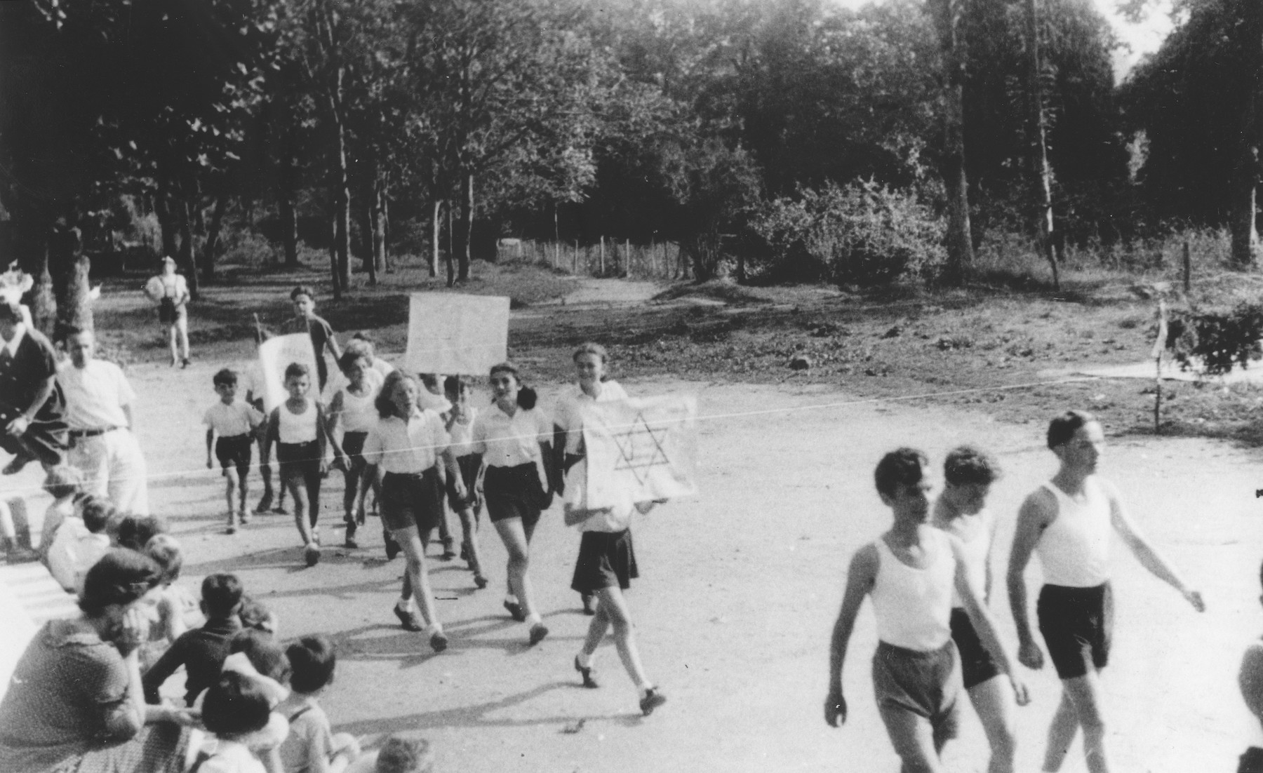 Jewish refugee children march with signs in front of the Chabannes children's home on sports day. 

Later that day, French police raided the home and removed several of the older children, who were then deported to Auschwitz.

Among those pictured are Gerard Rosenzweig, Alex Kramskoi, Angel Haas, Louise Bontnik, Elsi Wolf, Anatole Zilberstein and Stephan Lewy.