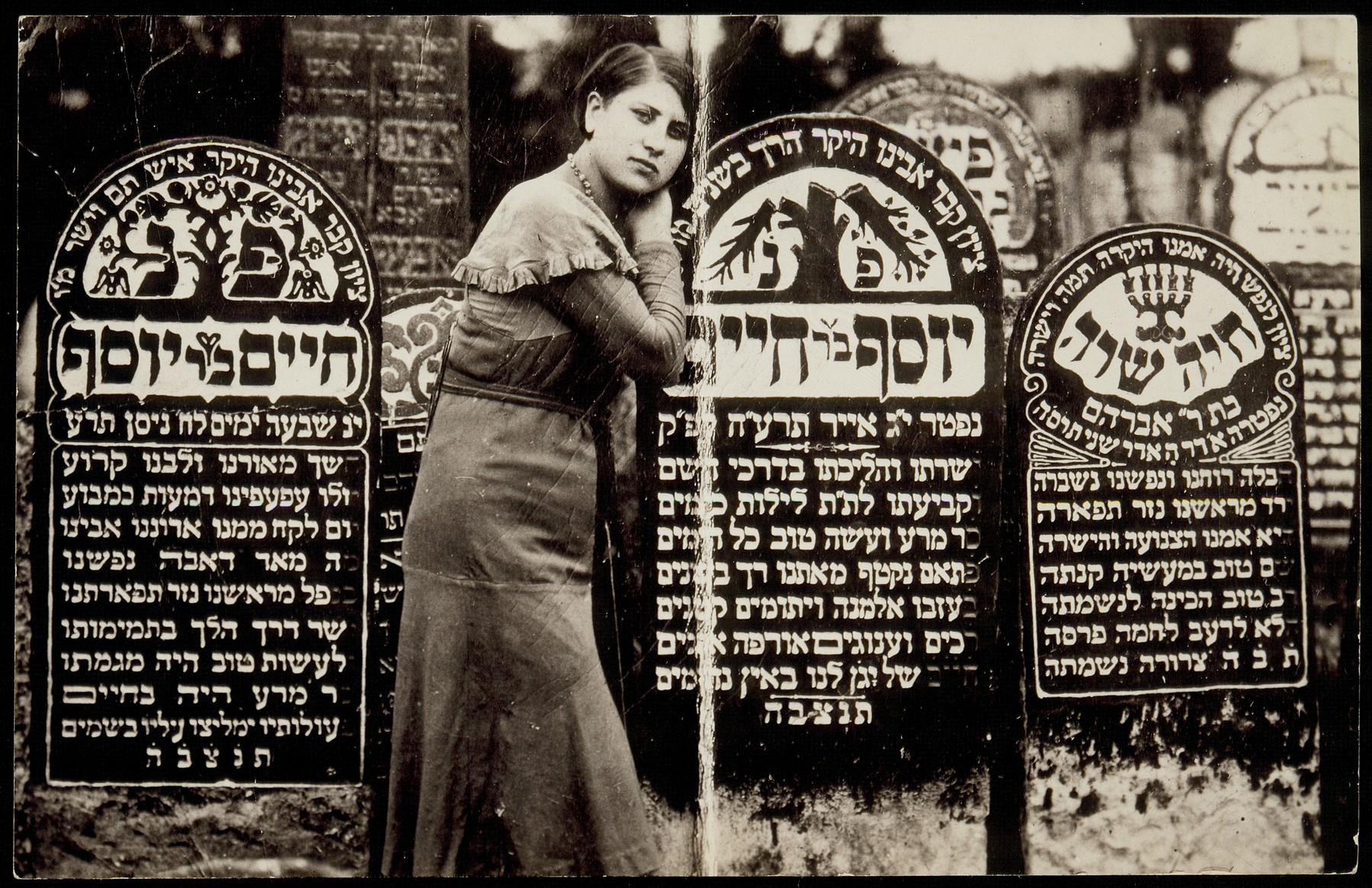 Rivka Shuster stands at the grave of her father Joseph who died in 1915. 

On her right is the grave of her grandfather Hayyim Shuster, who died in 1910.  Rivka survived the Holocaust in hiding with her son Joseph who was born on January 31, 1943 in the forest