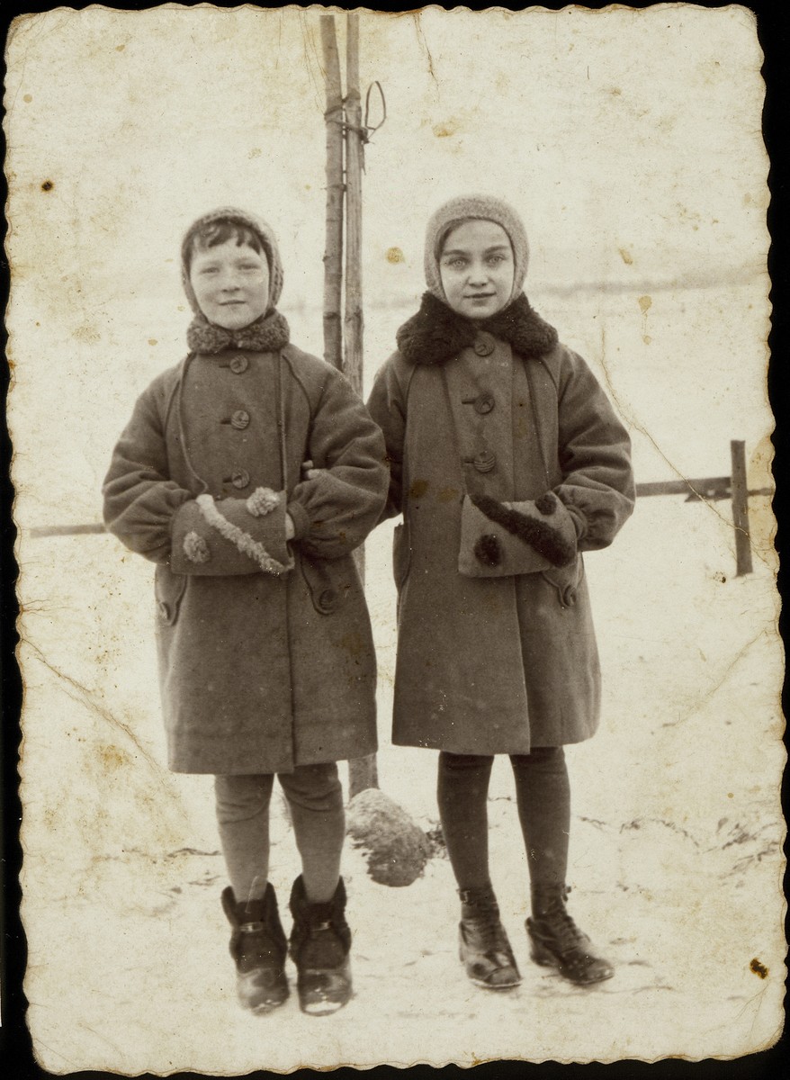 Nehama Paikowski (right) and her friend, Freeda Yurkanski pose together in winter coats and muffs. 

On September 26, 1941,  horse-drawn carriages stopped in front of the hospital and took the sick, and mothers who had just given birth and their new-born infants to the mass graves to be killed.  Nehama was among the patients who was taken from the hospital to the killing fields. Freeda was also murdered on that day.
