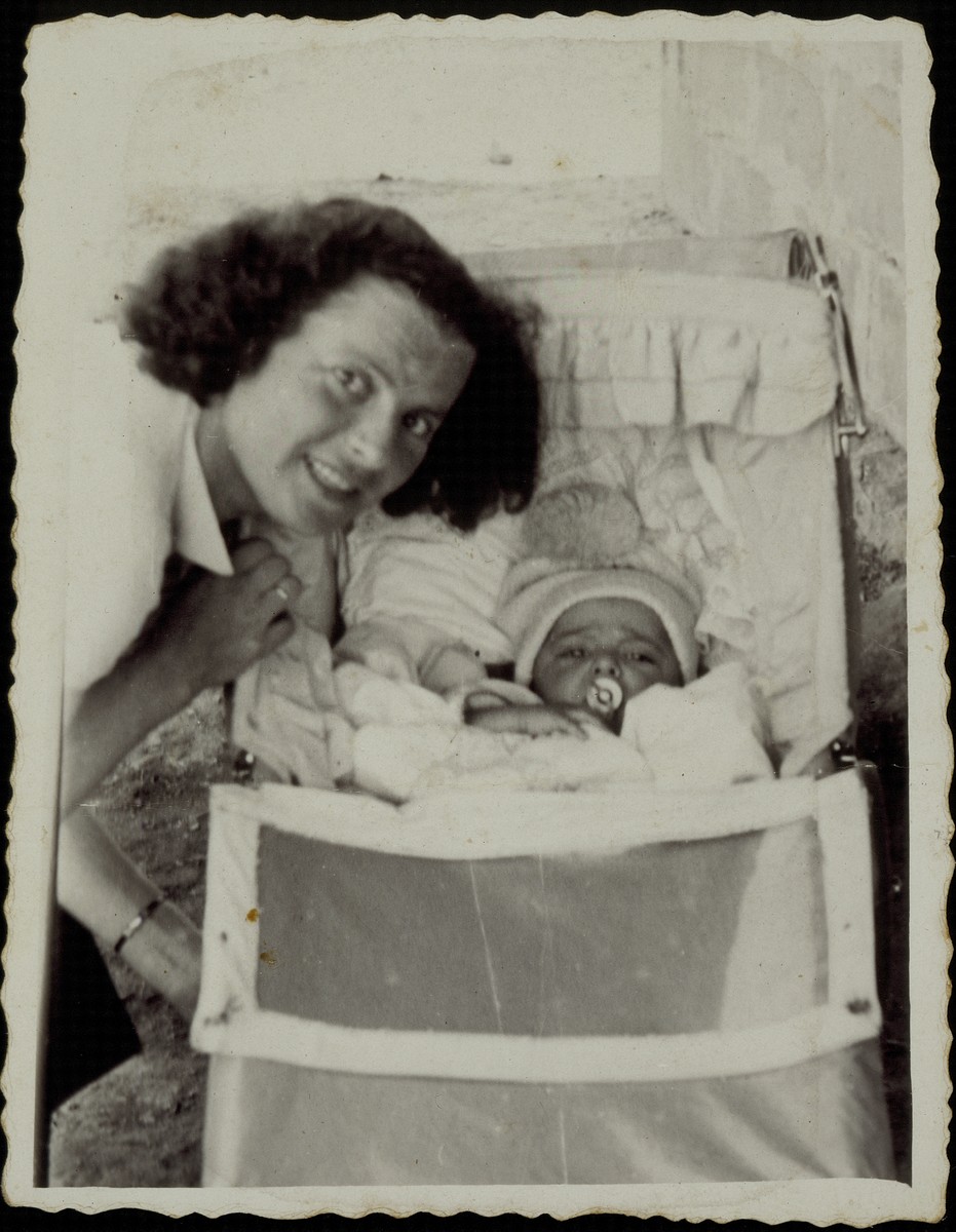Beila Gaikowski poses next to the cradle of her newborn son Yitzhakl.  

Both Beila and Yitzhakl Gaikowski were murdered by the Germans during the September 1941 mass killing action in Eisiskes.