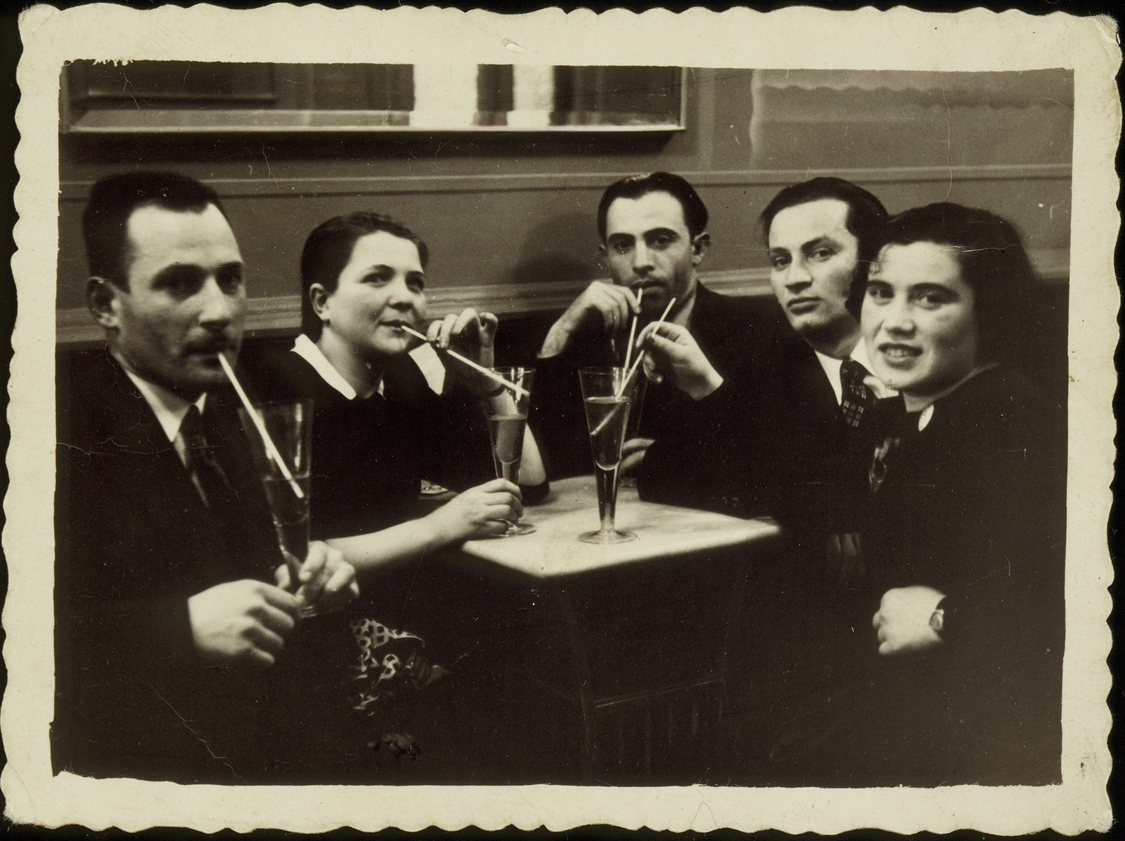 Etchke Jurdyczanski celebrates his plans to immigrate to Palestine in a restaurant in Vilna. 

Etchke Jurdyczanski (Isaac Juris), is second from right.  He survived the Holocaust in Siberia, and the fate of the others is unknown.