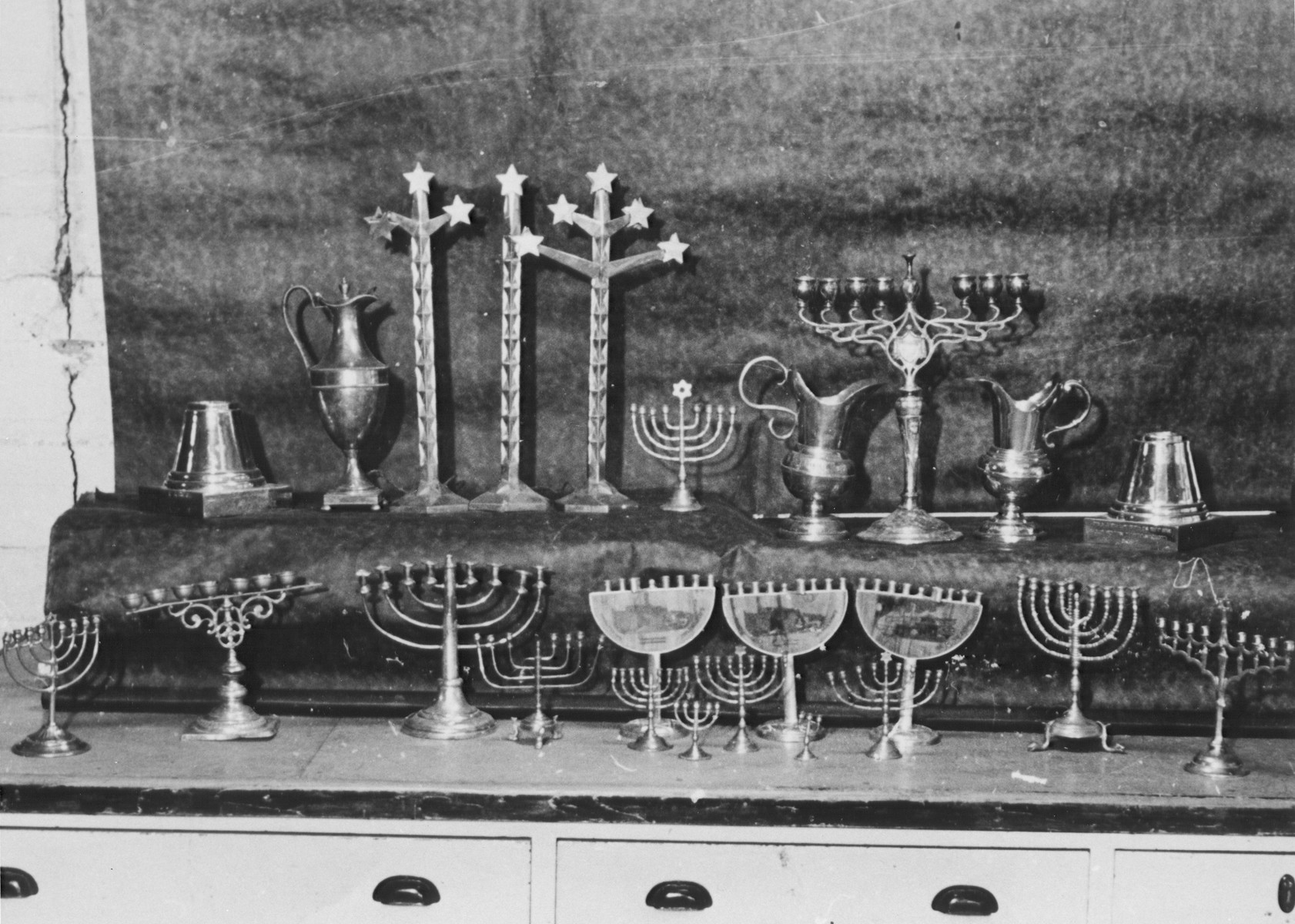 Display of silver Hanukkah menorahs and other ritual articles confiscated by the Nazis.