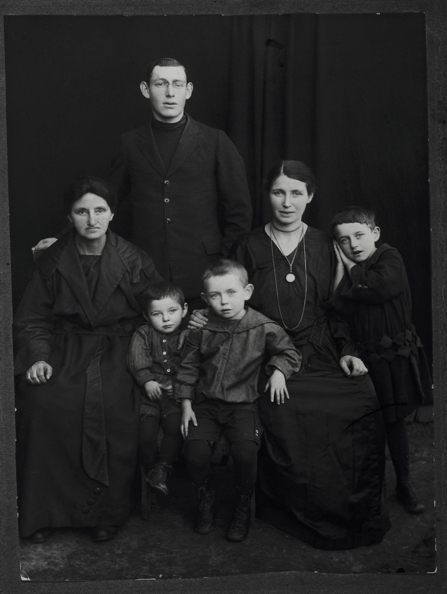 Studio portrait the Pick/Gendelman family in Rokitno, Poland.

Pictured clockwise from the far left are: Esther Malka Pick (mother of Chantzia), Itzik Pick (brother of Chantzia), Chantzia (Pick) Gendelman, Thema Gendelman, Herschel Gendelman and Moniek Gendelman.