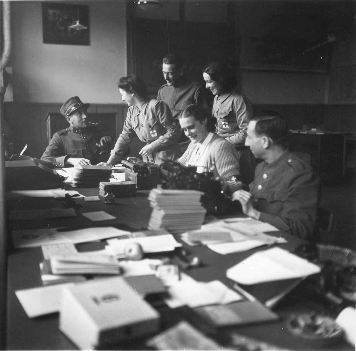 Swiss Red Cross workers and military reservists organize the documentation for Jews rescued from Theresienstadt.