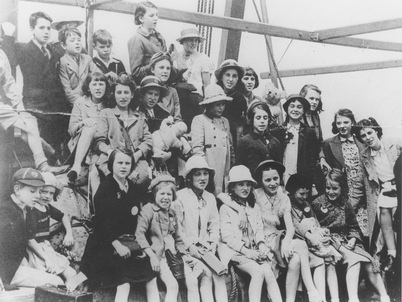 Group portrait of Jewish refugee children from Germany and London, on the deck of the MS Batory as the ship arrives in Melbourne.

Pictured standing in the second row, on the right (wearing a light dress and a dark jacket, with braids) is Jean Schultz (later Saltzman).