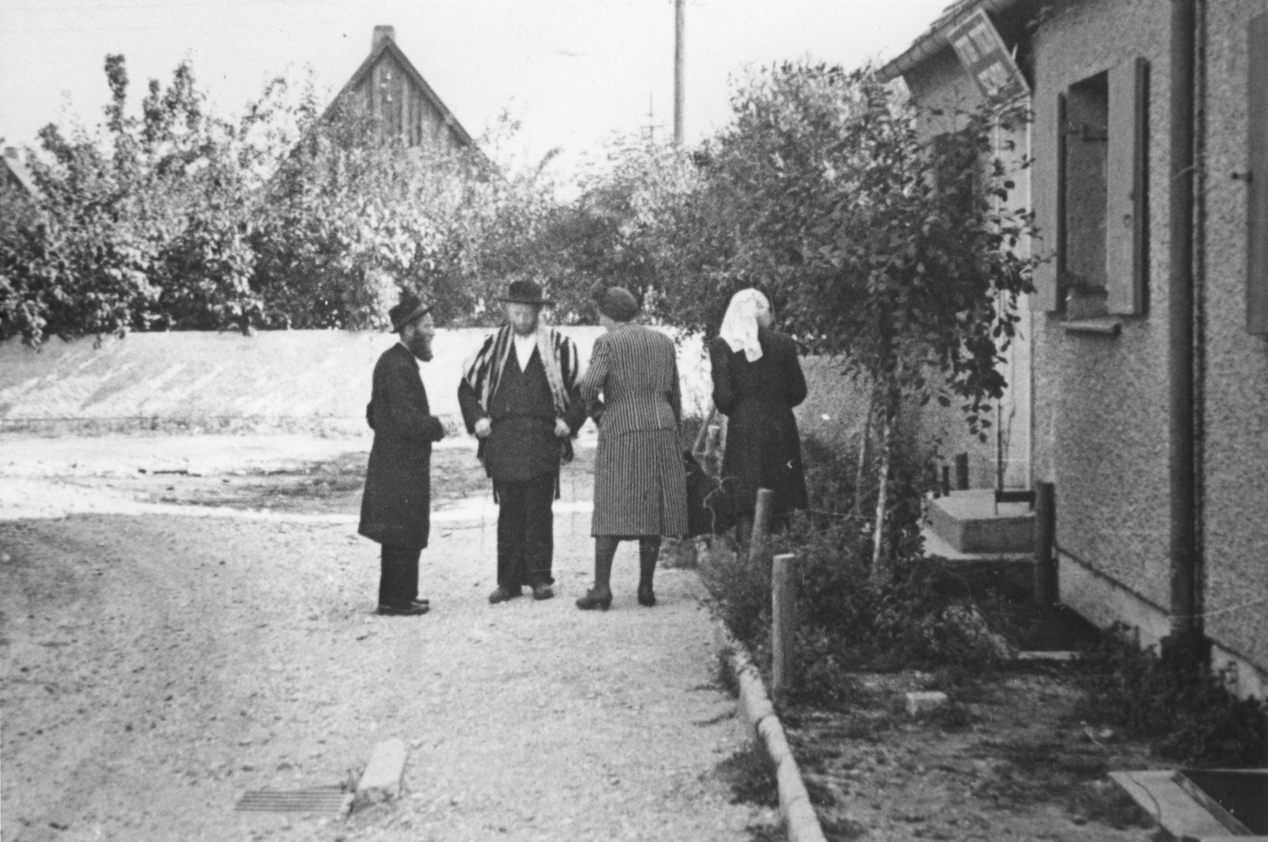 Religious Jews meet outside the synagogue in the Neu Freimann displaced persons camp.