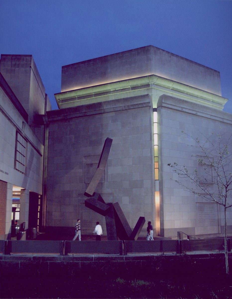 Nighttime view of the 15th Street entrance to the U.S. Holocaust Memorial Museum, in which the Hall of Remembrance is illuminated.