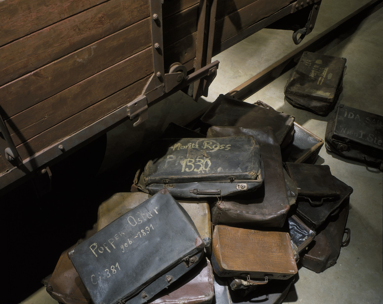 A collection of valises belonging to Jews who were deported to death camps, that are displayed at the base of the railcar on the third floor of the permanent exhibition at the U.S. Holocaust Memorial Museum.