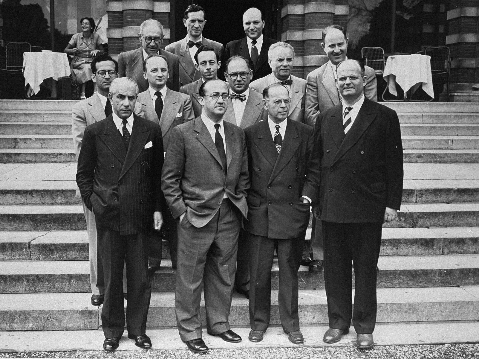 Group portrait of members of the Conference on Jewish Material Claims that came to Luxembourg for the signing of the Reparations Agreement between the German Federal Republic, the State of Israel, and the Conference on Jewish Material Claims. 

Among those pictured is Benjamin Ferencz (second row from the front, second from the left).