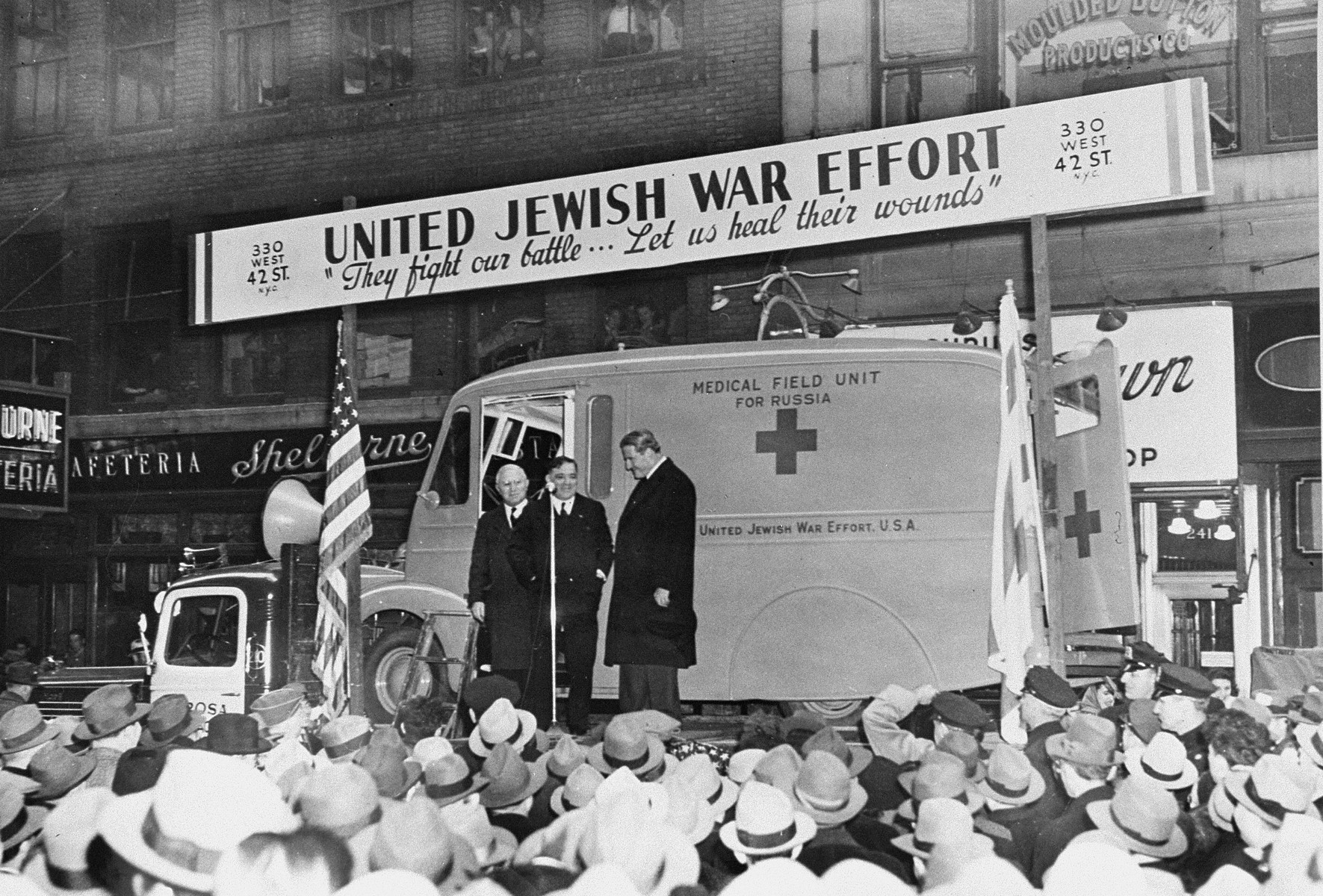 Dr. Joseph Tenenbaum stands with Fiorello LaGuardia and Rabbi Stephen S. Wise in front of a medical field unit sponsored by the United Jewish War Effort that is being sent to the Soviet Union.