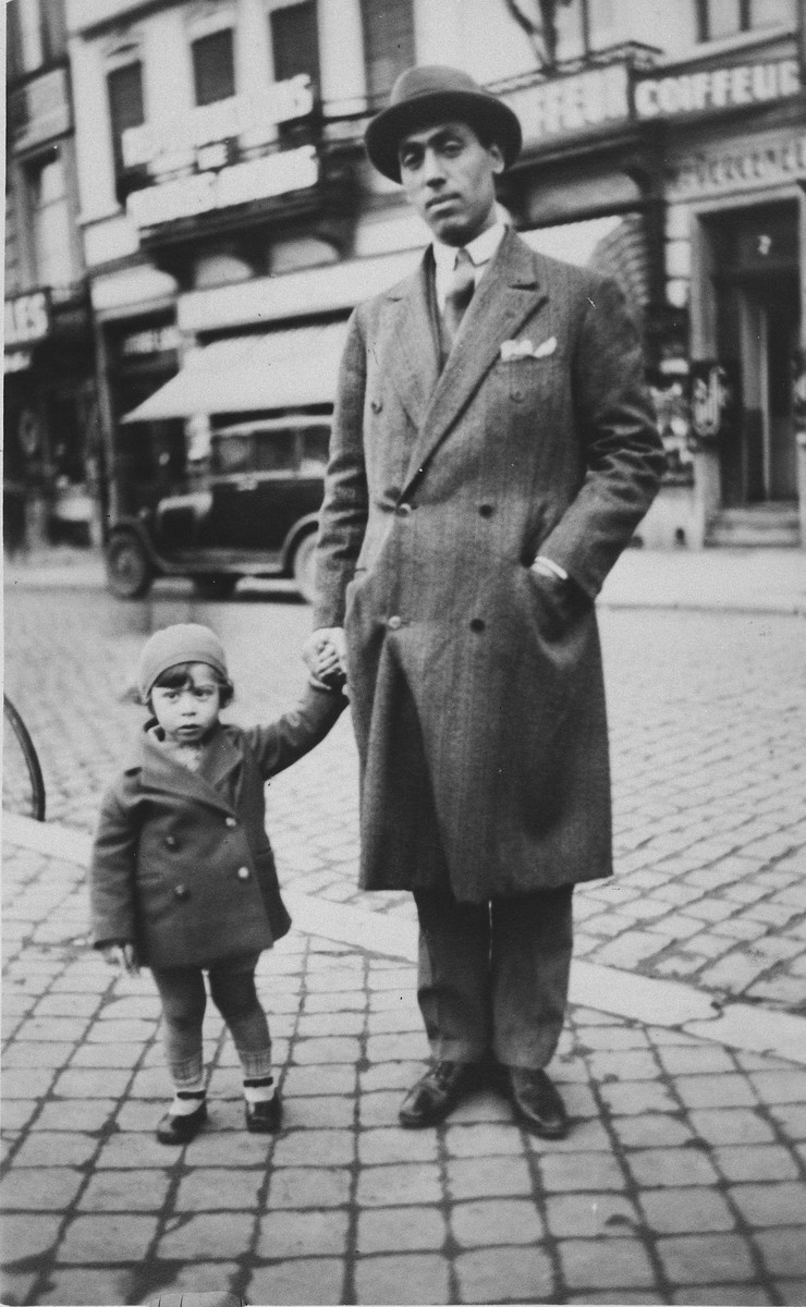 Michelene Frances walks down a street in Brussels with her father.