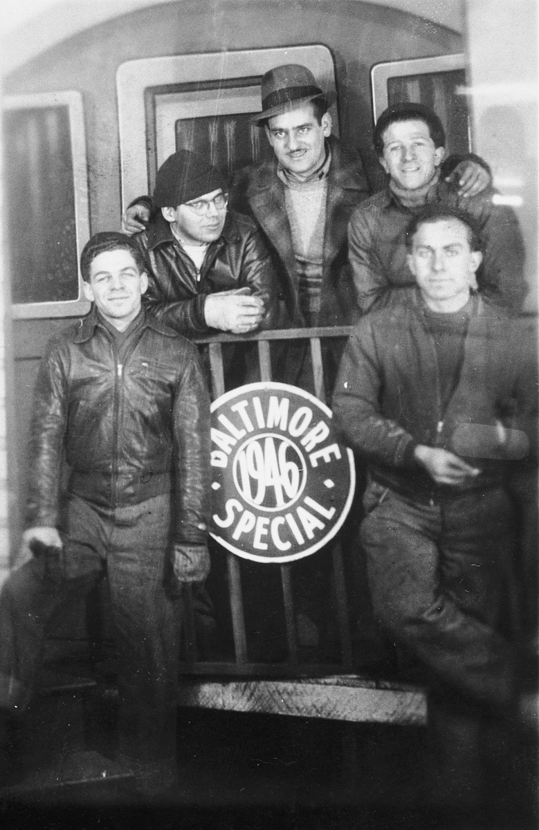 Five crew members of the President Warfield (later the Exodus 1947), pose around a sign that reads "Baltimore 1946 Special" in Baltimore.

Pictured from left to right are: Avi Livney, Shmuel Beeri (Baer), Eli Kalm, Itzhak Aronowitz and Cyril Weinstein.