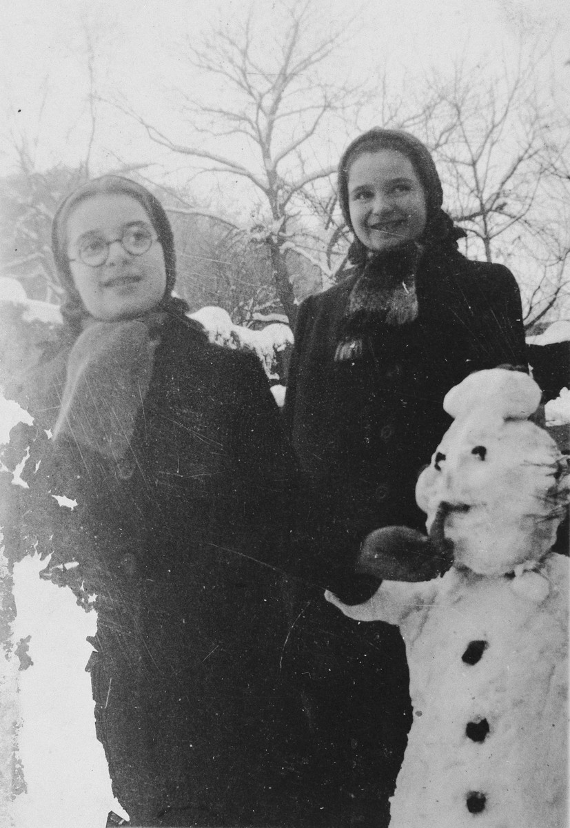 Agnes and Zsuzsi Laszlo build a snowman outside their mother's pension in Miskolc.