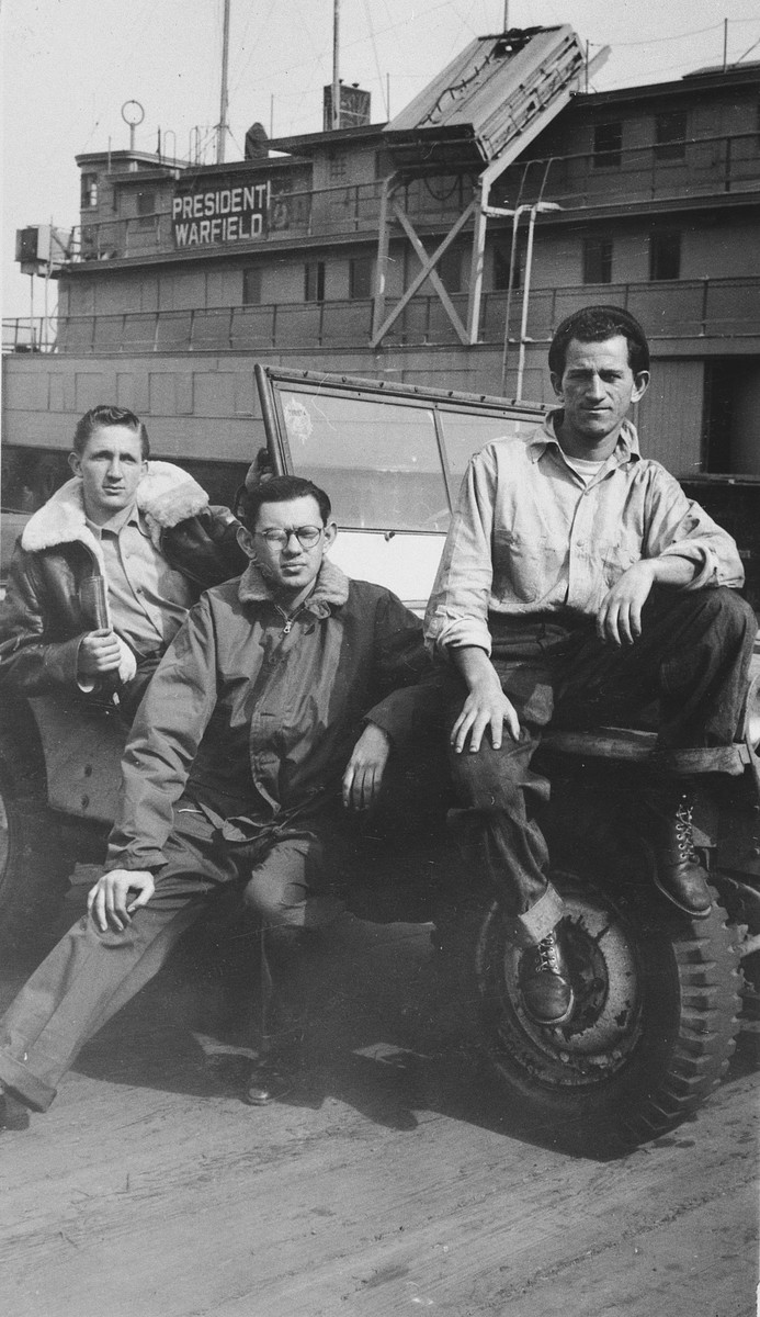 Three crew members pose on the pier in front of the President Warfield (later the Exodus 1947).

Pictured from left to right are: Reuben Margolis, Shmuel Schuller and Avraham Siegel, all from Mexico.