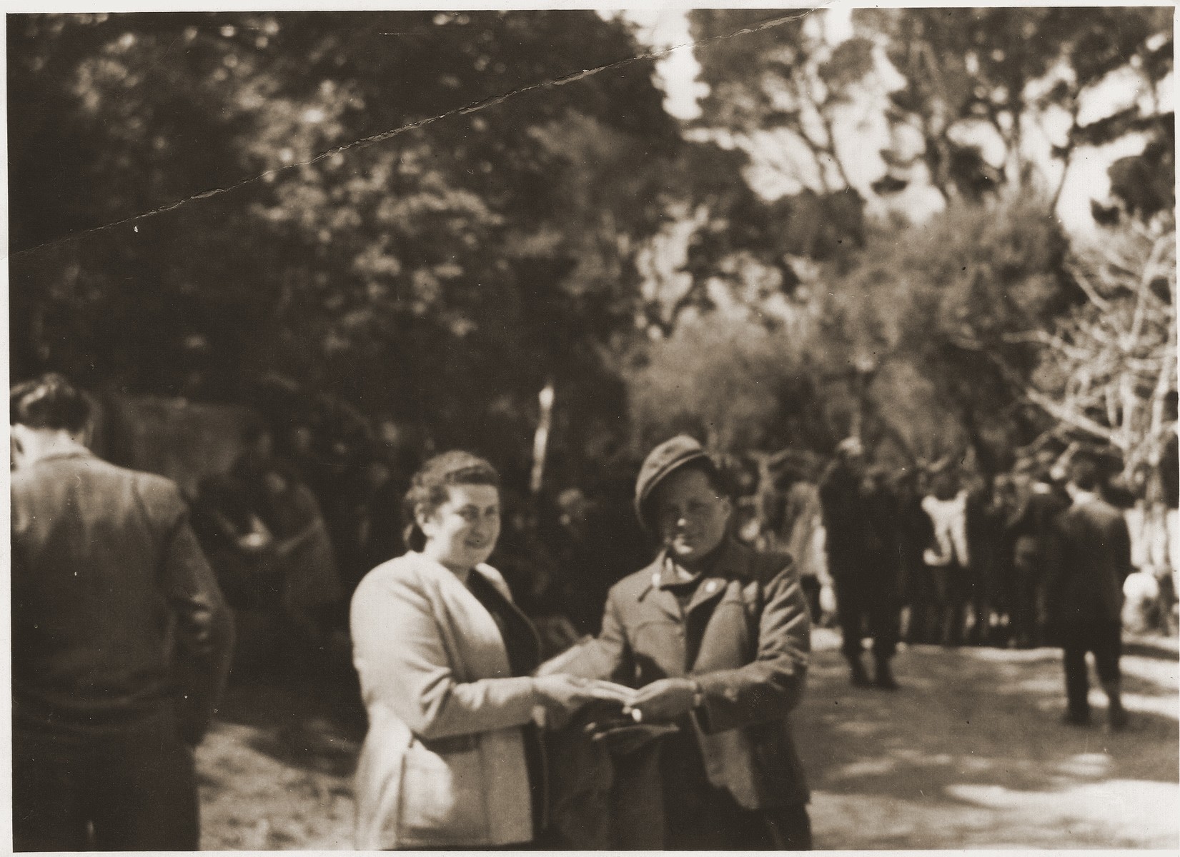 Hadassah Bimko and poses with another DP at the Marsylia transit camp (a former Yugoslav POW camp) in Marseilles.

Bimko icame to Marseilles to accompany a transport of Jewish orphans from the Bergen-Belsen displaced persons' camp who will  board the SS Champollion for Palestine.
