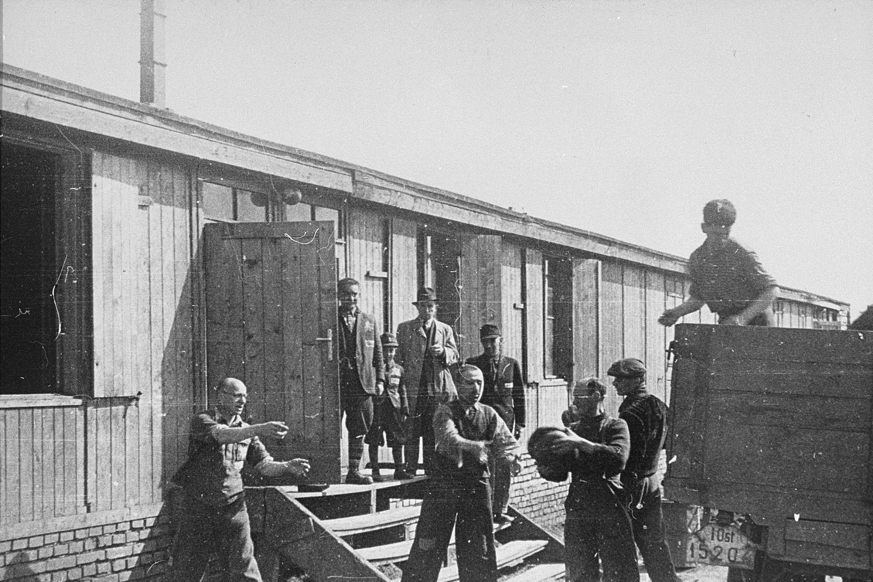 Jewish prisoners in Plaszow unload bread into part of the Madritch factory.  

The Madritch factory utilized concentration camp labor to produce uniforms for the German army.