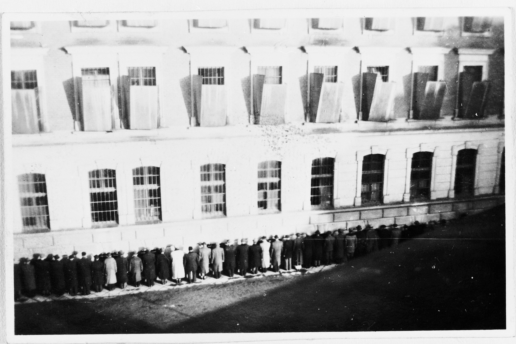 Civilians arrested by German police are held prisoner in the courtyard of the Montelupich prison in Krakow.