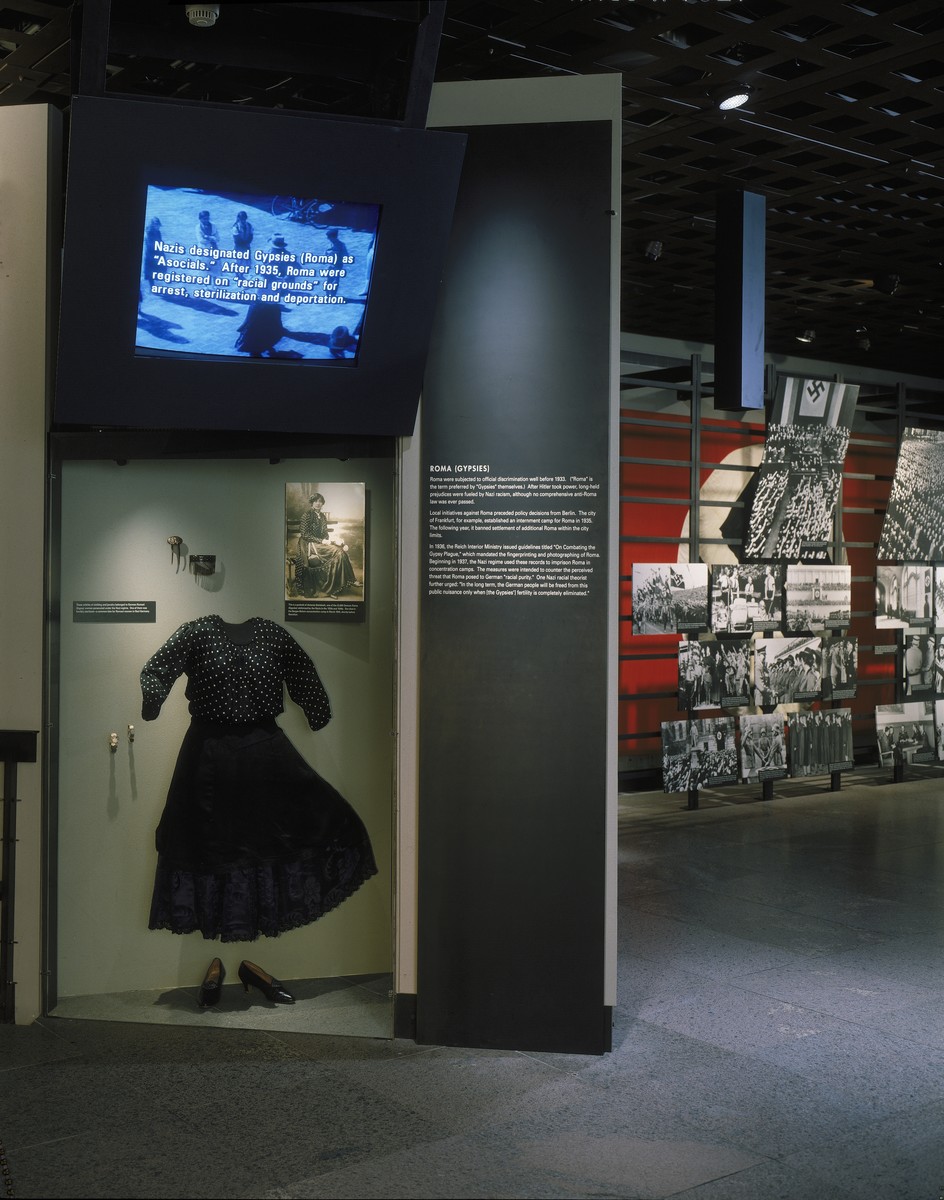 View of a display case featuring a dress worn by a Romani woman from Czechoslovakia, on the fourth floor of the permanent exhibition in the U.S. Holocaust Memorial Museum.