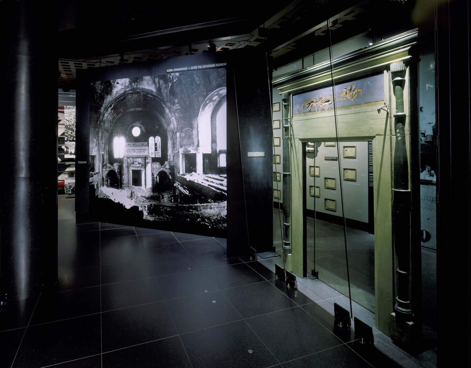 View of the Kristallnacht segment, featuring a desecrated torah ark from Nentershausen, Germany and a photo mural of the destruction of the Essen synagogue, on the fourth floor of the permanent exhibition at the U.S. Holocaust Memorial Museum.