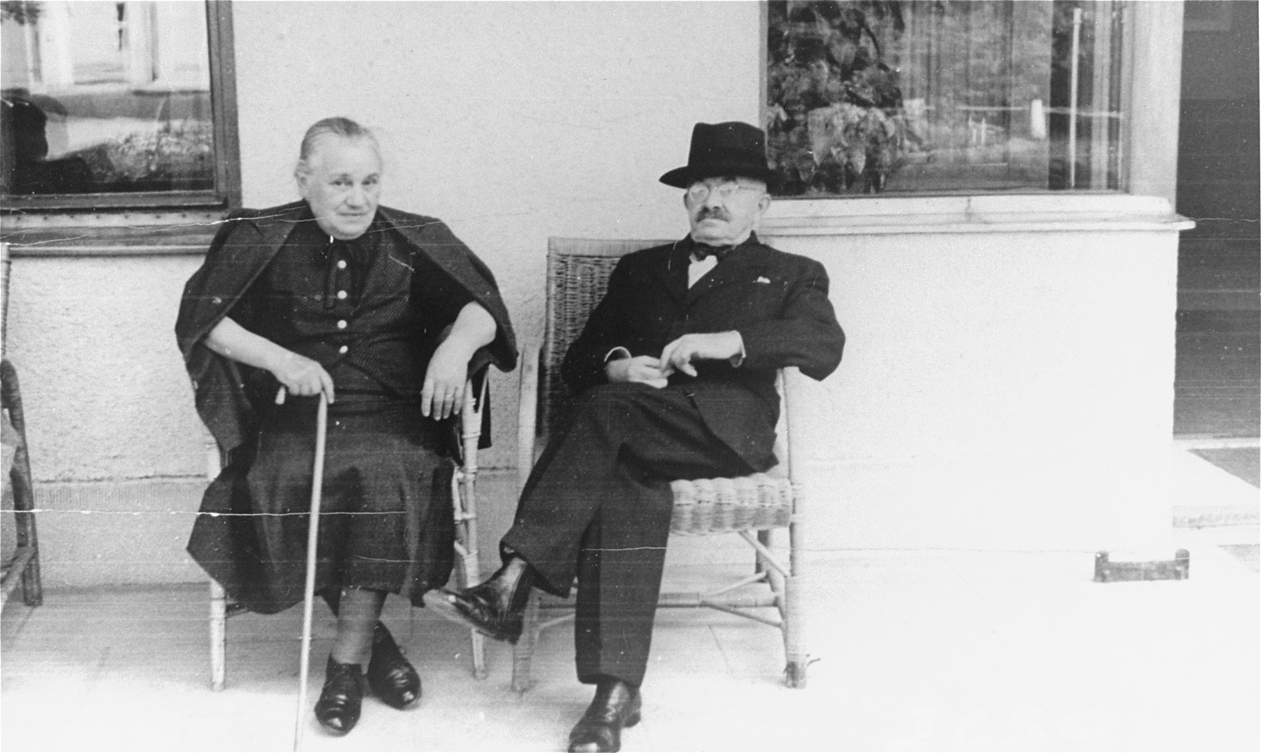 Portrait of the donor's in-laws, Ignac and Sophie Muller, sitting on their porch in Sered, Czechoslovakia.