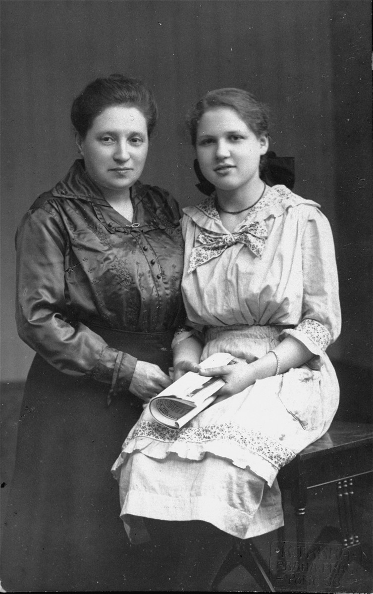 Studio portrait of a Jewish mother and daughter in Prague, Czechoslovakia.

Pictured are Olga (Ola) Fischl with her daughter, Clothilde.  Olga was the sister of Emilia Kohn (who was married to Viktor Kohn).  Both Olga and Clothilde perished during the war.