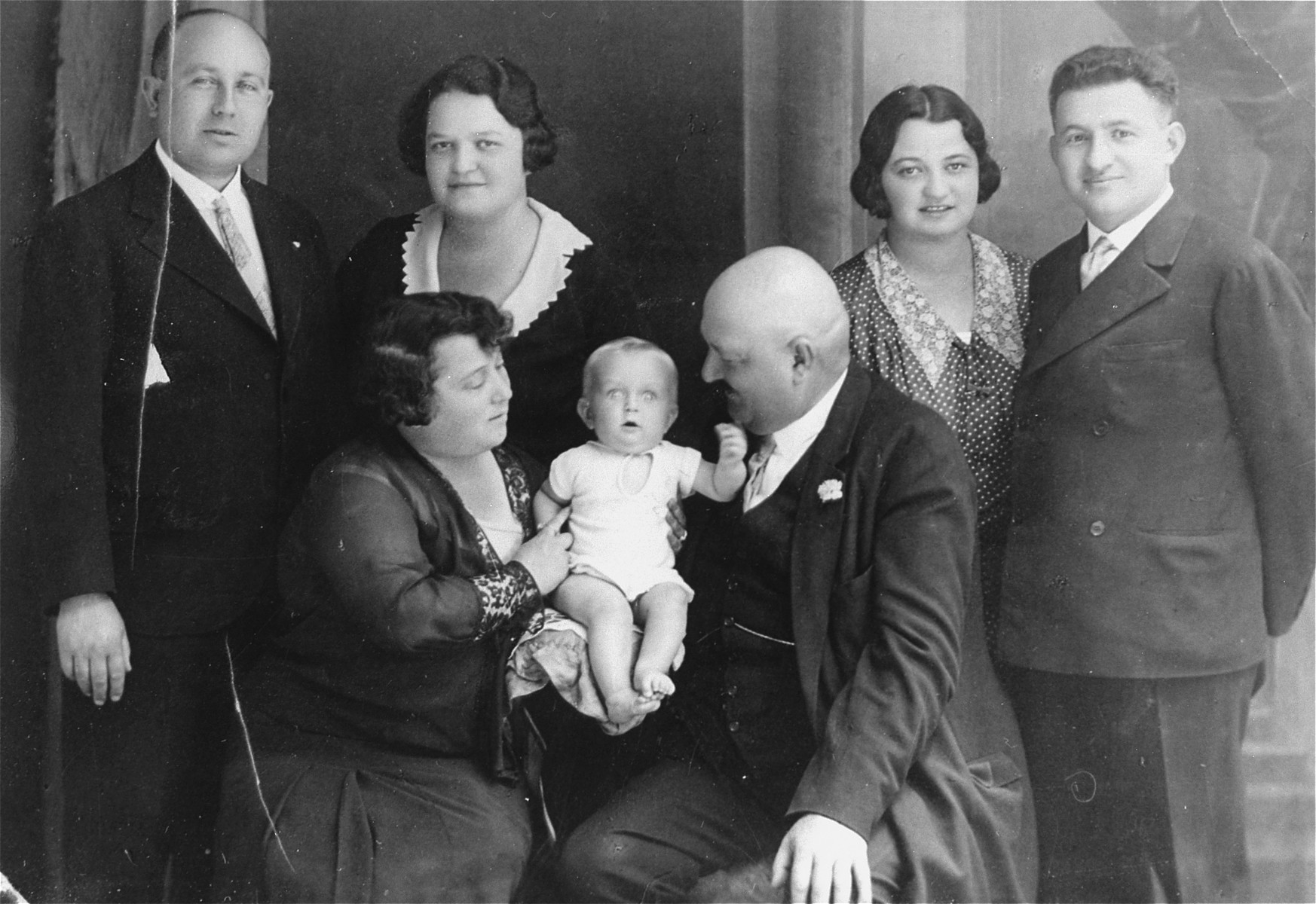 Portrait of the extended Herzog family at the home of Julie and Andi Szanto in Slovensky-Meder.

Pictured standing are Andi and Julie Szanto (left) and Magda and Nandor Muller (right).  Seated left to right are Lilly Herzog, Gyorgy Szanto, and Jakub Herzog.