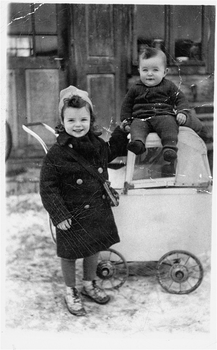 Two young children play outside next to a baby carriage in Bogdan, Transcarpathia.

In 1944, the children and their mother were deported from Bogdan to Auschwitz, where they all perished.  The father, Aharon Sendel, escaped from a labor camp, joined a partisan group and after the war immigrated to Israel.