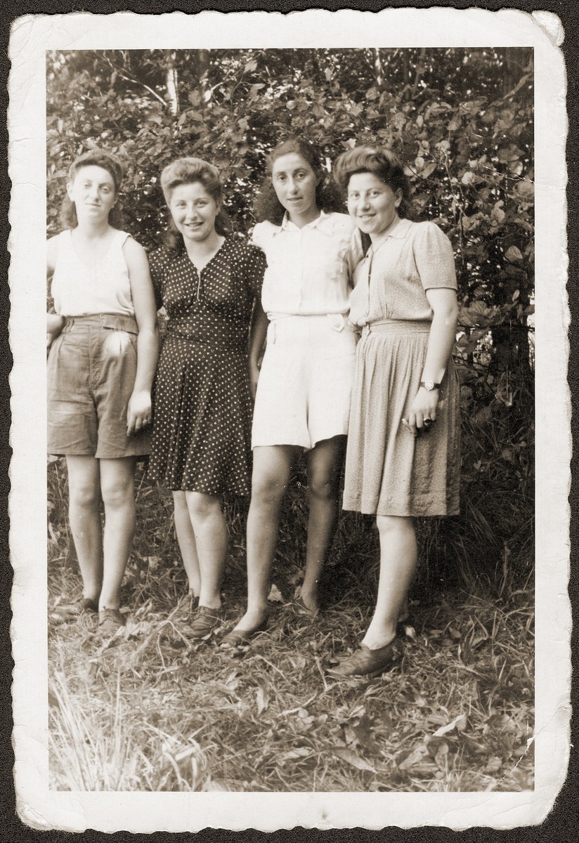 Four young Jewish women pose outside at the Eschwege displaced persons camp.  

Among those pictured are Hania Goldman (second from the left) and her sister, Rachela (far right).