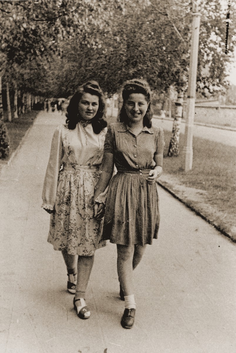 Hania Goldman (right) and her friend, Tosia Szechter (Schneider), walk down a street in the Neu Freiman displaced persons camp.