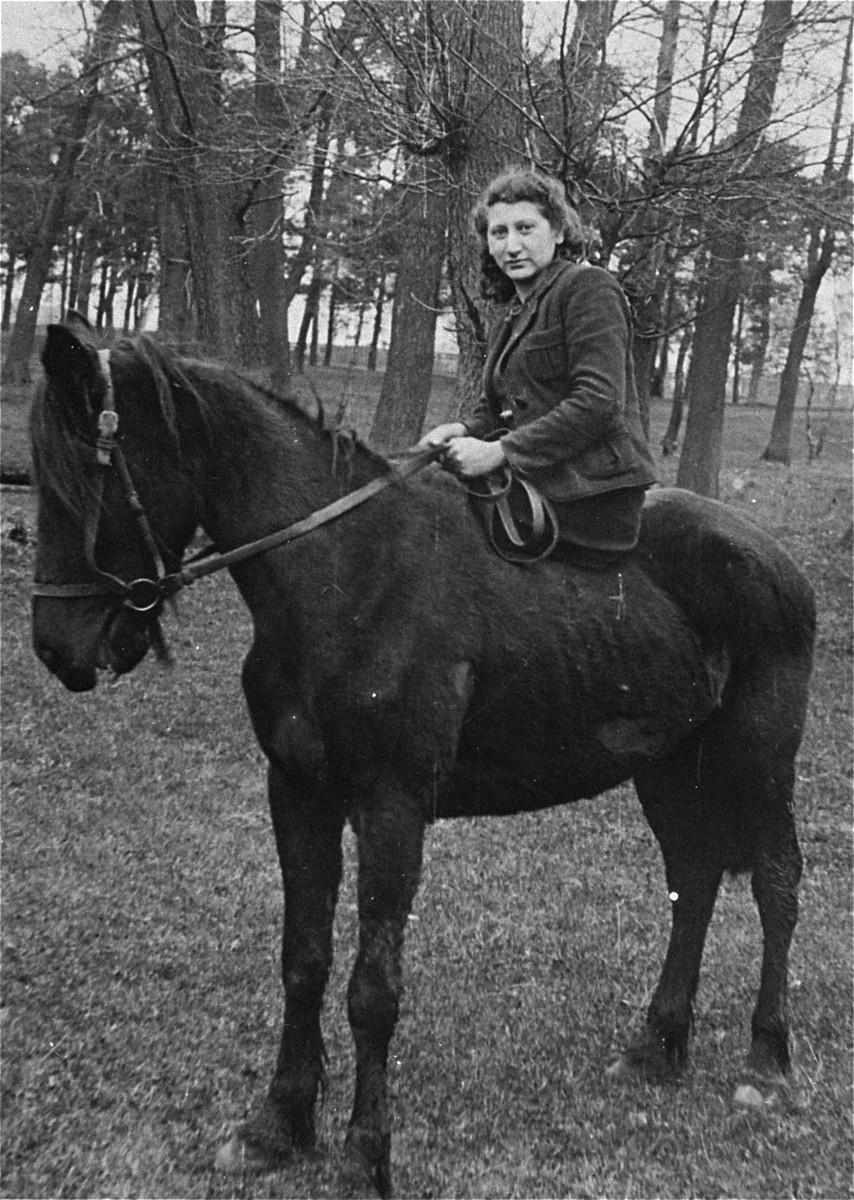 Chagit Elster, a member of the Hashomer Hatzair Zionist collective, rides the only horse on their farm in Zarki.