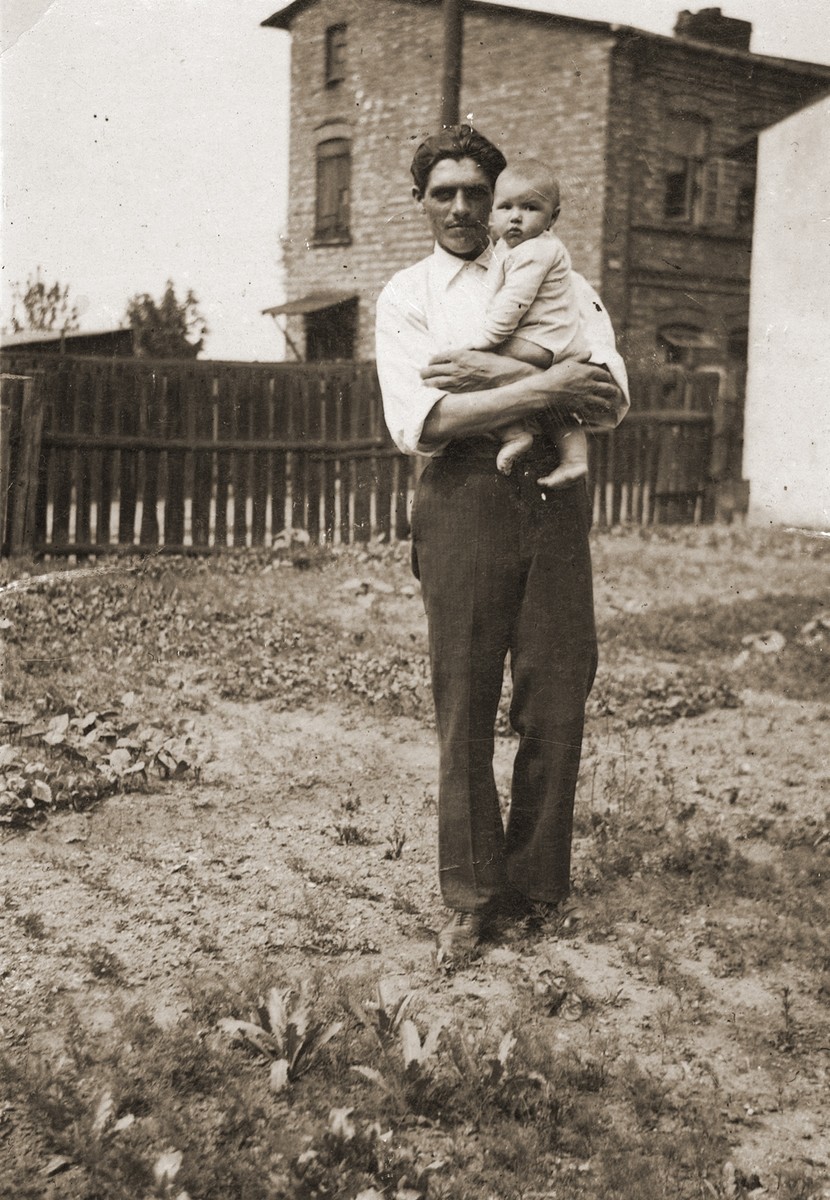 Portrait of Polish rescuer Stefan Gromol holding his infant child.