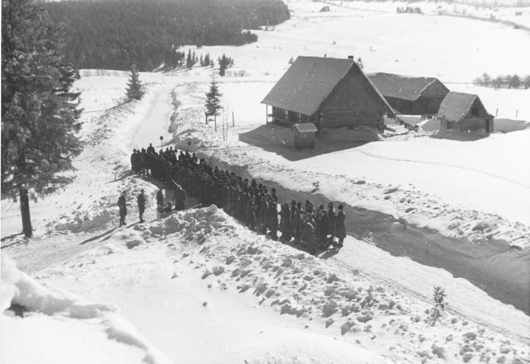 Jewish conscripts in Company 108/57 of the Hungarian Labor Service assembled for work clearing snow from roads.