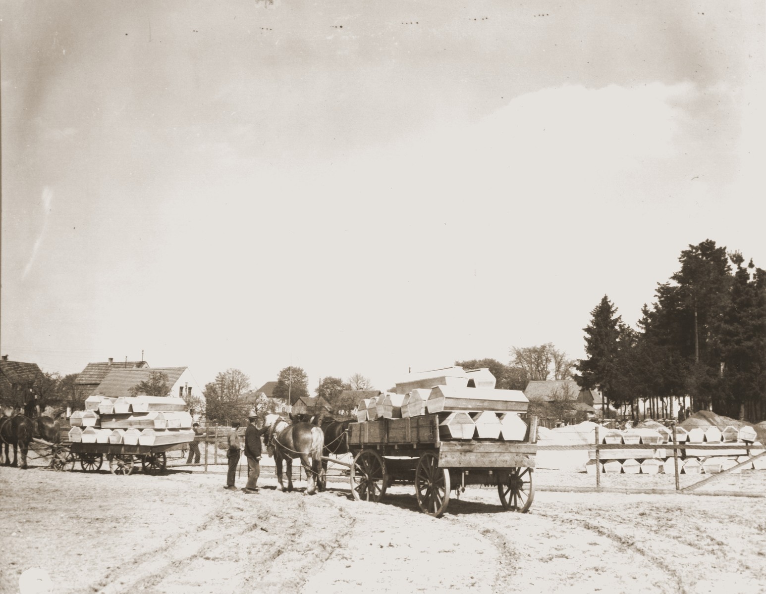 German civilians from Schwarzenfeld transport coffins by wagon to a mass grave near the town from which 140 bodies were exhumed.  

The victims died while on an evacuation transport from the Flossenbuerg concentration camp.