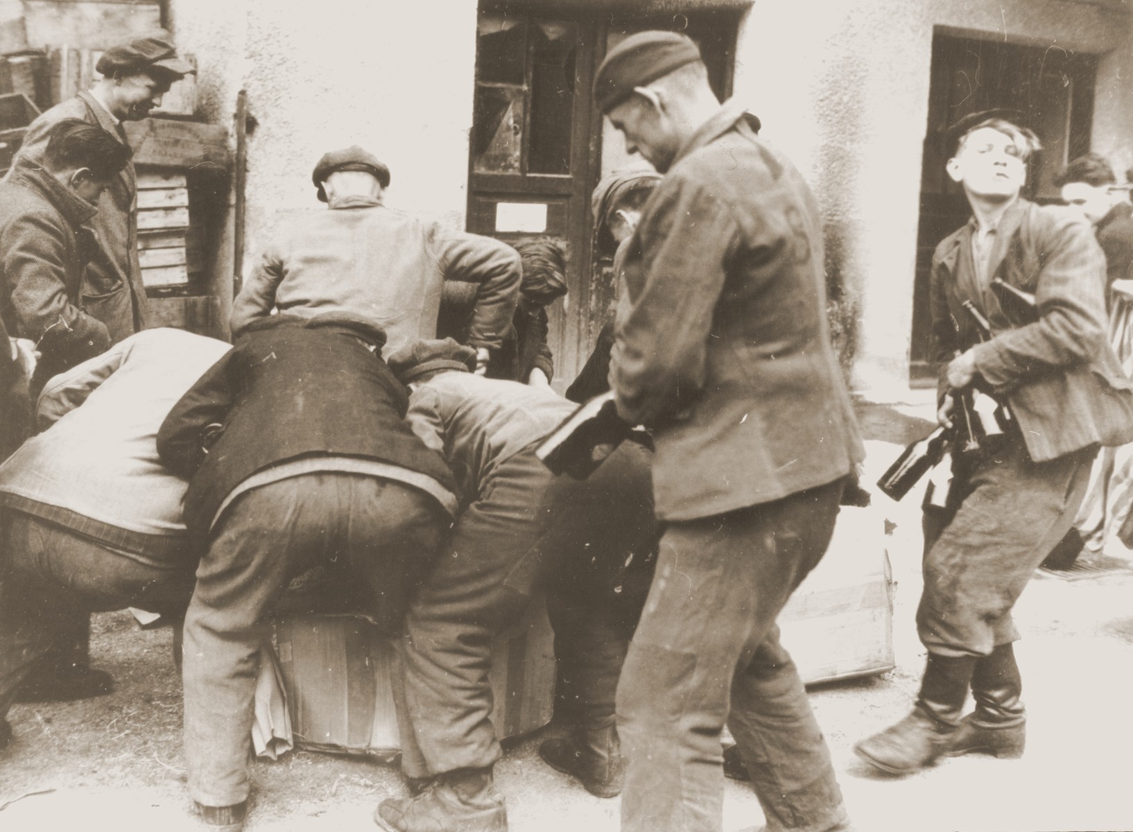 Liberated concentration camp prisoners loot food and supplies in Munich.