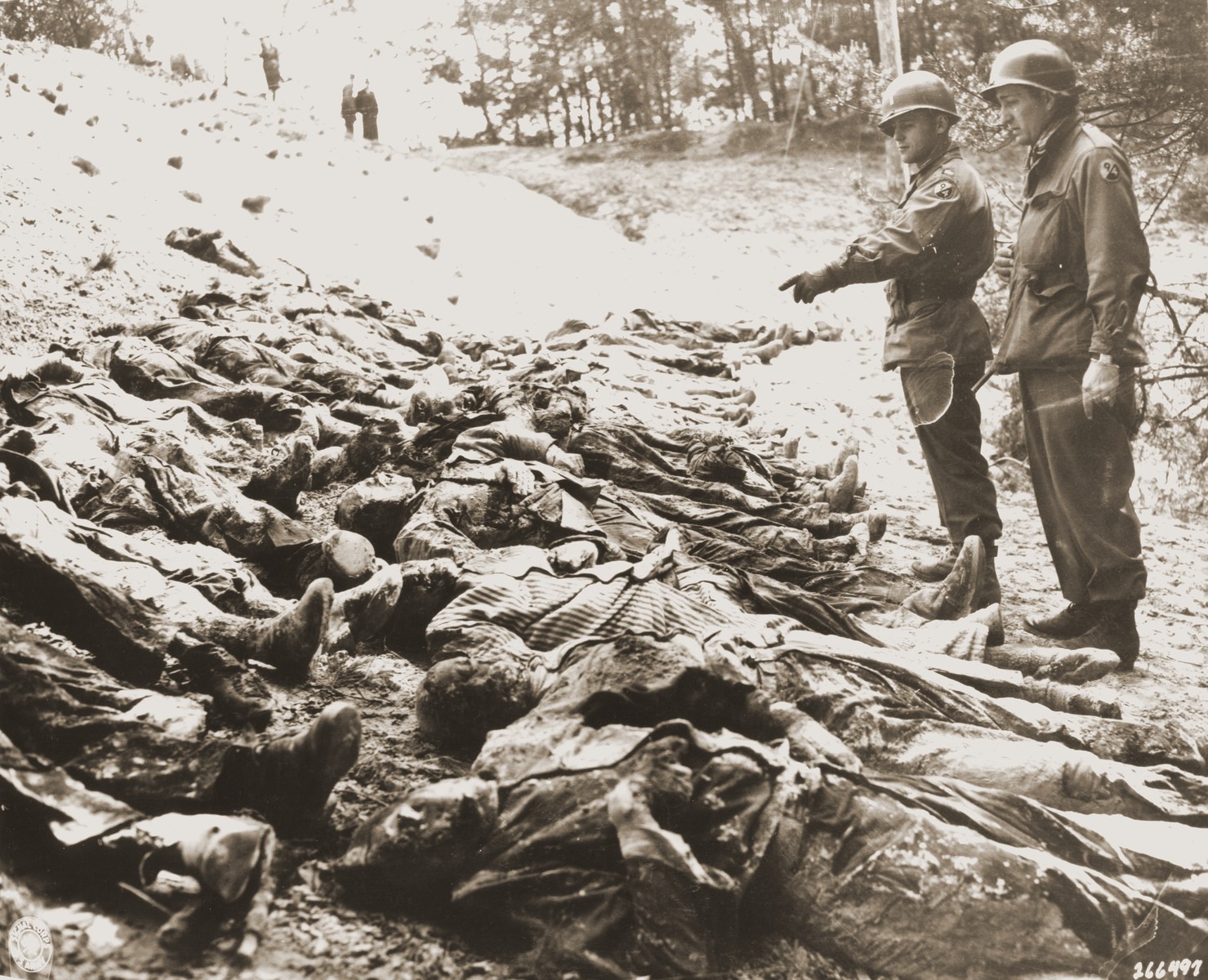 Two American officers with the 94th Division count the bodies of 71 political prisoners exhumed from a mass grave on Wenzelnberg near Solingen-Ohligs.

The victims, most of whom were taken from Luettringhausen prison, were shot and buried by the Gestapo following orders to eliminate all Reich enemies just before the end of the war.