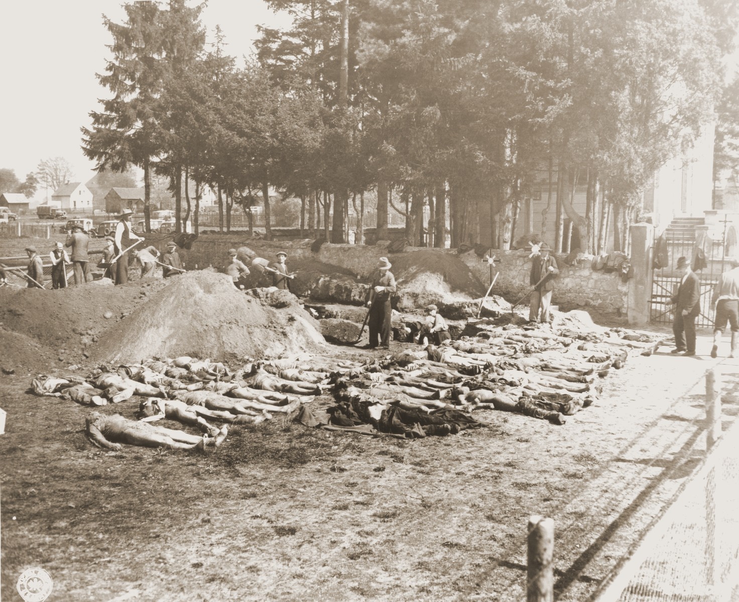 German civilians from Schwarzenfeld dig graves for the 140 Hungarian, Russian, and Polish Jews exhumed from a mass grave near the town.  

The victims died while on an evacuation transport from the Flossenbuerg concentration camp.