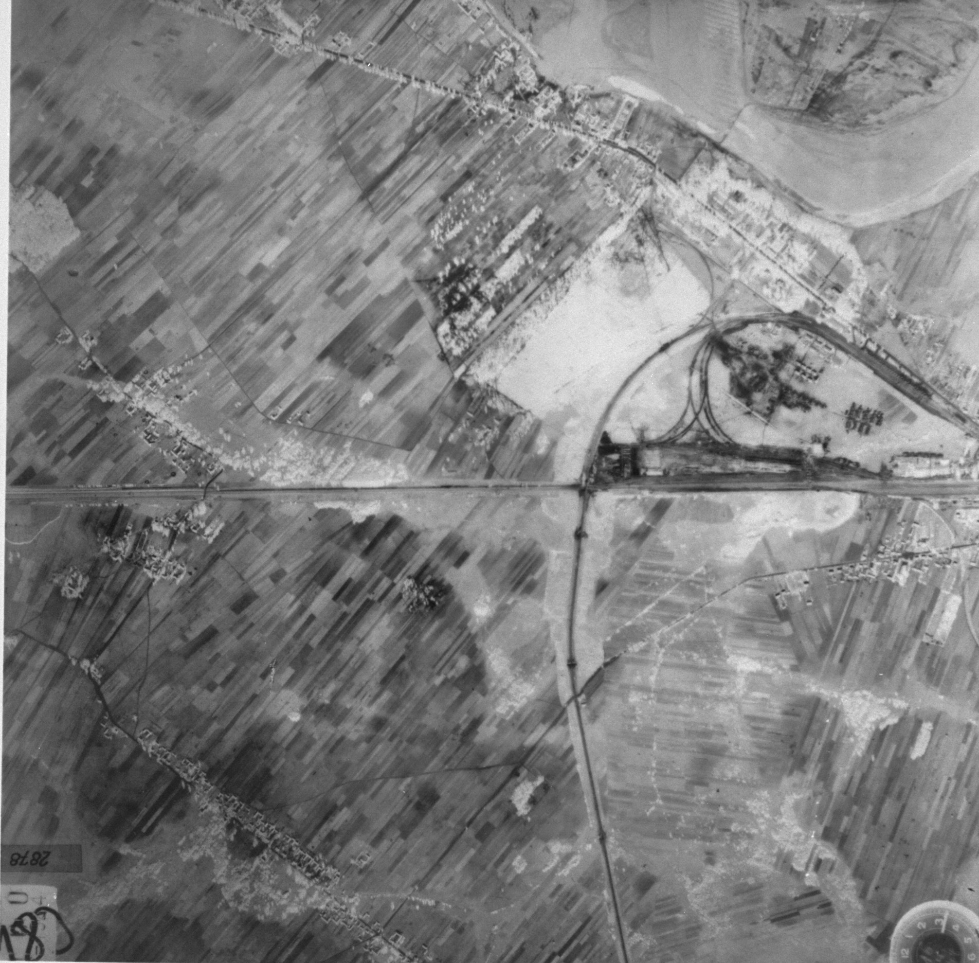 An aerial photograph taken by the German air force.

The photo appears to depict the rail line in Malkinia Gorna, and may indicate where the deportation train transports from Warsaw in 1942-43 turned south and crossed the Bug River toward Treblinka.