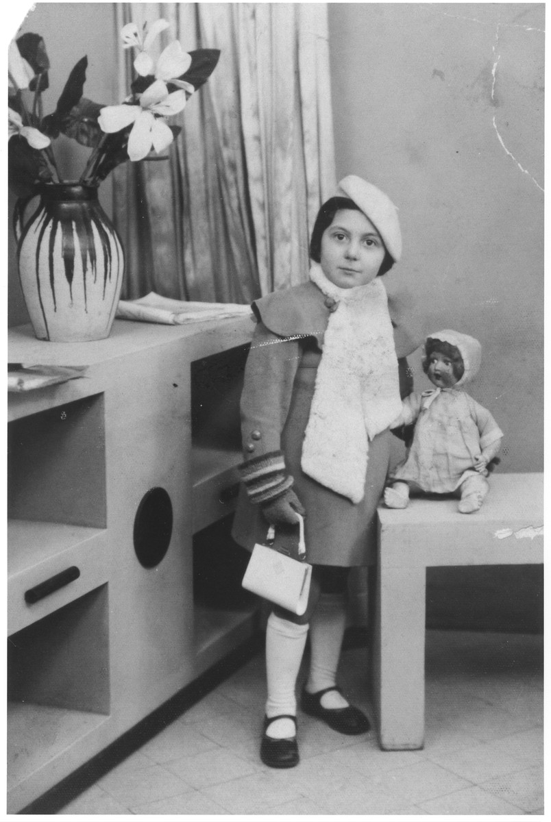 Studio portrait of five-year-old Rachel Kokotek with a doll.