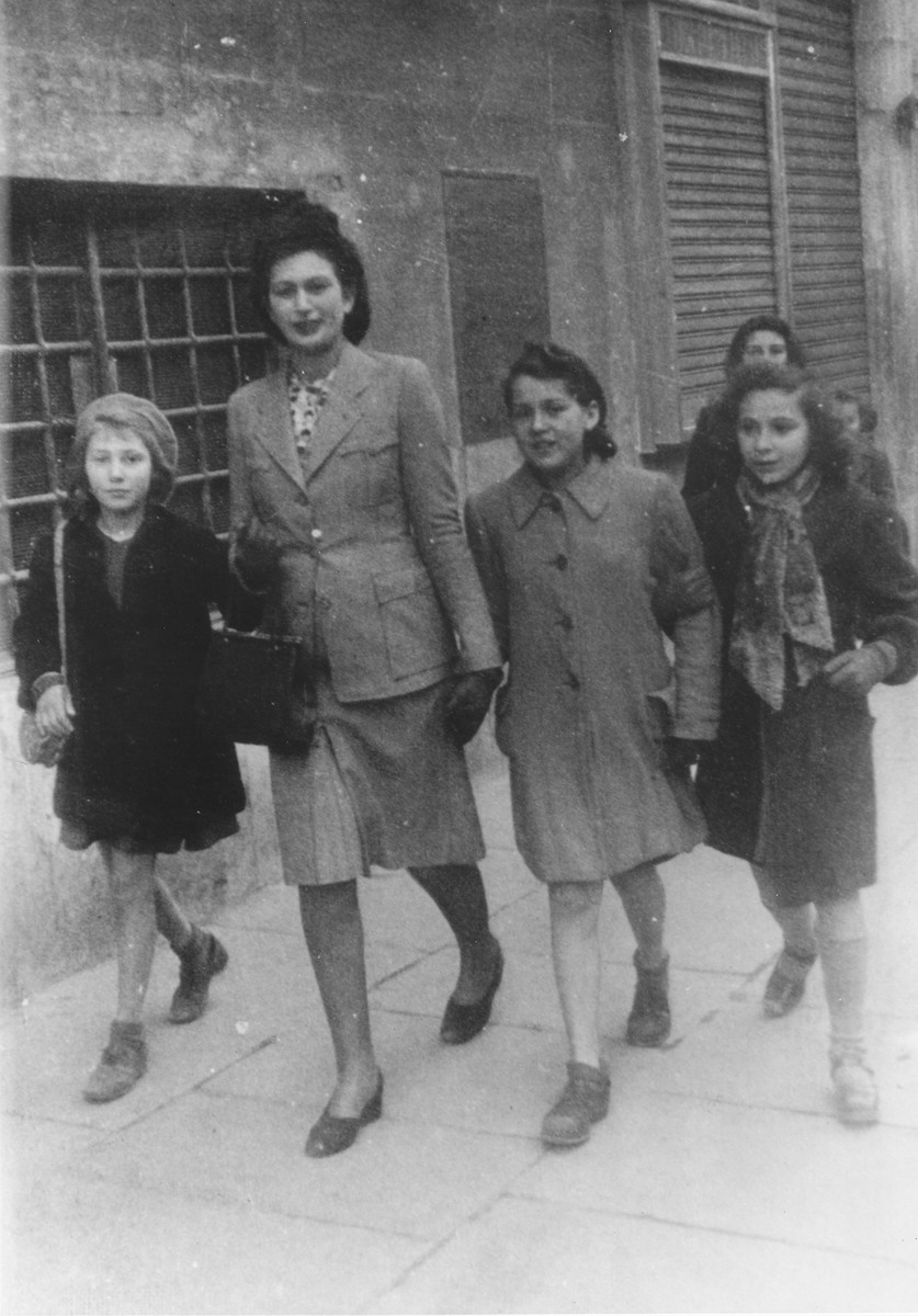 Hanna Rawicz walks along a street in Rome with friends during the period before she went into hiding in a convent.

Among those pictured are Hanna Rawicz (first from the right); Sonja Salem (second from the right); and Anna Ehrenberg (first from the left).