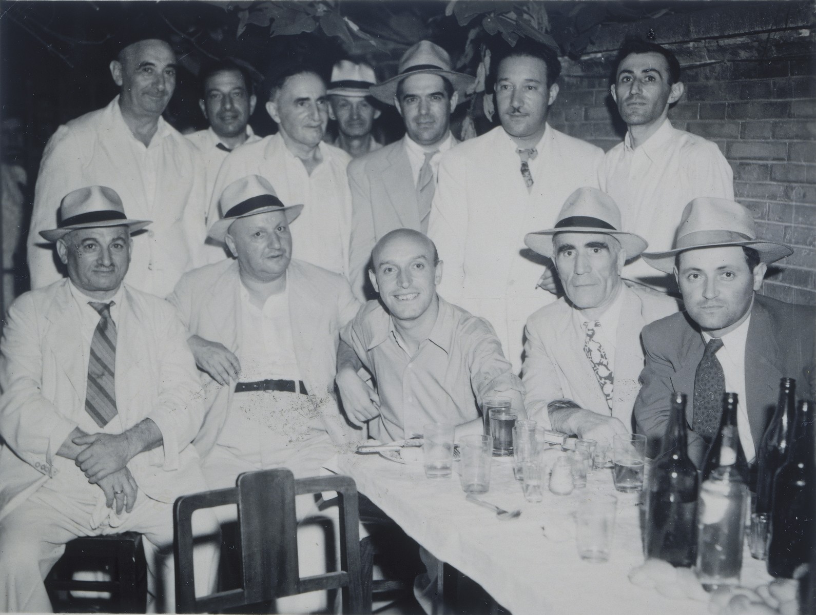 Group portrait of members of the Mir Yeshiva in Shanghai.

Hirsch Millner is seated at the bottom right.  Eli Rolavsky is standing on the far right.