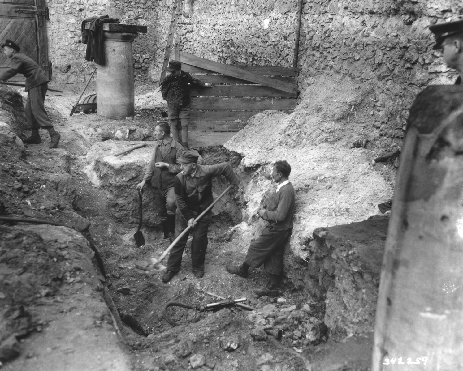German laborers dig in the courtyard of the Veldenstein castle, formerly owned by Hermann Goering, in search of property looted by the Nazi regime.