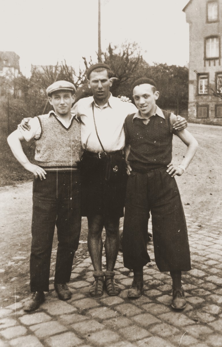 Three classmates from the Breuer Yeshiva pose during a bicycle trip through Bavaria.  

Pictured from left to right are Kurzweil, Blass, and Wolffs.
