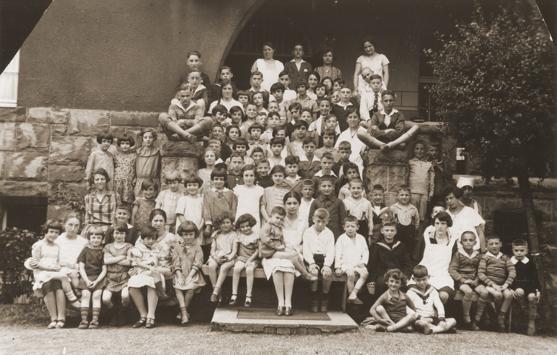 Group portrait of children at a Jewish summer camp.  

Pictured in the center is Gerd Zwienicki.  In front of him is Hannah Steinberg.